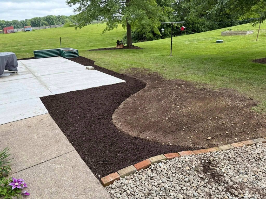 trimmed grass and mulch around patio